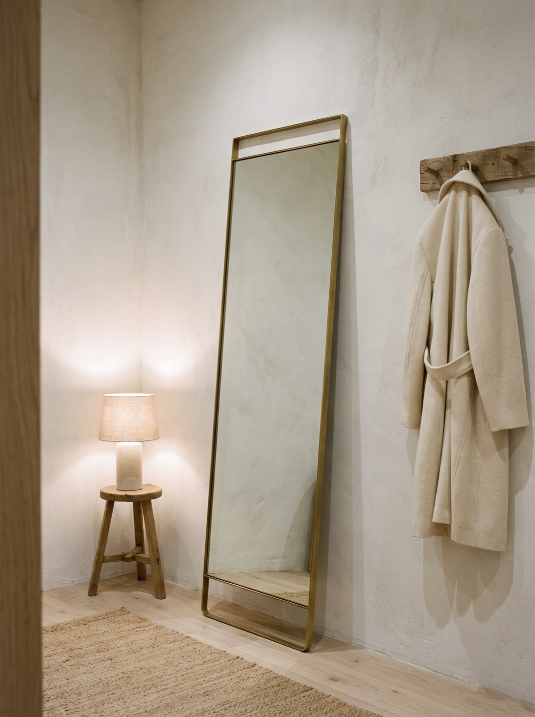Brass full-length mirror in a quiet corner of the shop
